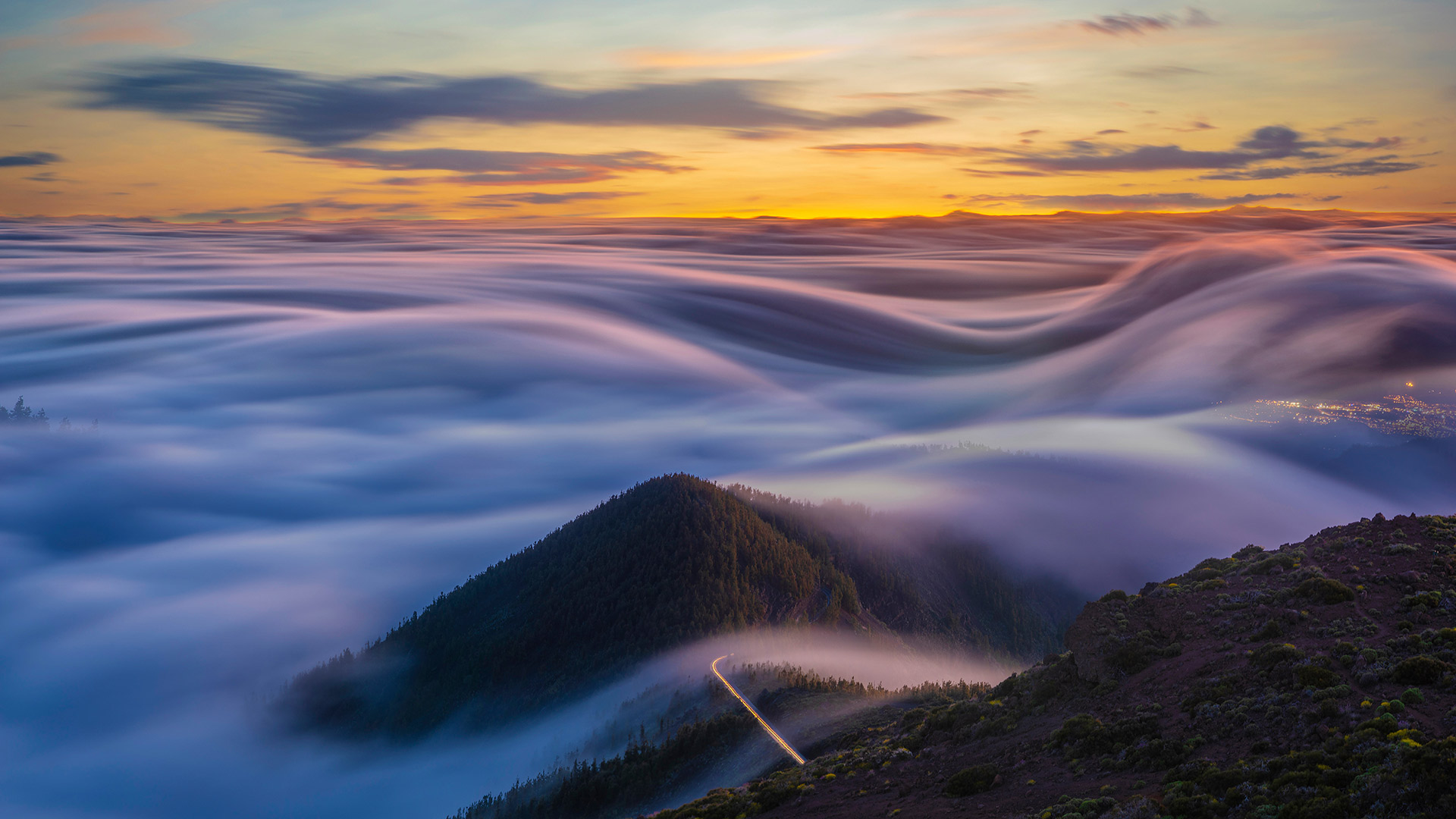 Flowing clouds over the Atlantic Ocean and Tenerife mountains, Canary Islands, Spain (© MikeMareen/iStock/Getty Images Plus)(Bing United Kingdom)
