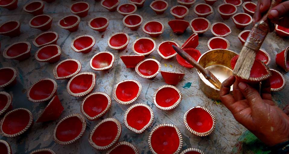 An Indian man paints earthen lamps for the forthcoming Diwali in India -- EPA/Corbis &copy; (Bing United Kingdom)