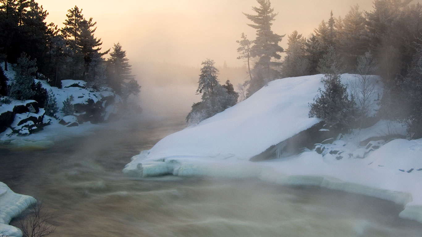Tree silhouettes and rising mists near rapids of Wanapitei River, Wanup, Ontario (© Don Johnston/All Canada Photos/Corbis)(Bing Canada)