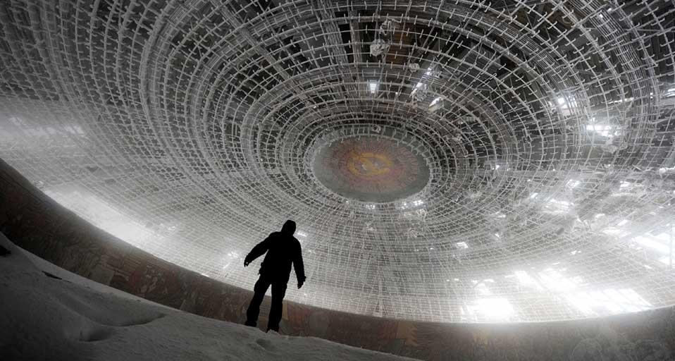 A man walks inside the crumbling skeleton of the House of the Bulgarian Communist Party on Mount Buzludzha, Bulgaria (© Dimitar Dilkoff/Getty Images) &copy; (Bing United Kingdom)