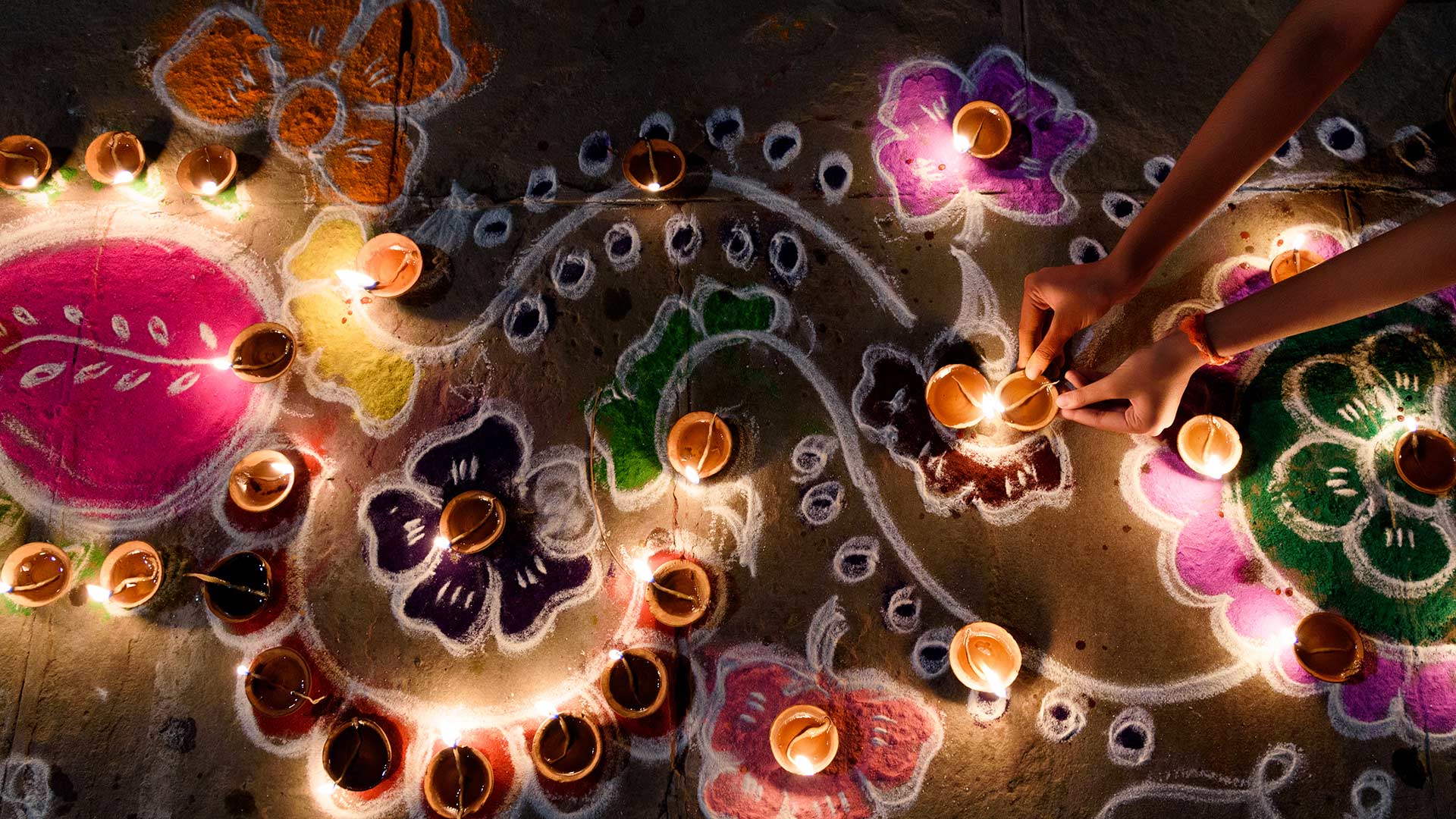 Oil lamps being arranged on rangoli during Diwali (© Subir Basak/Getty Images)(Bing United Kingdom)