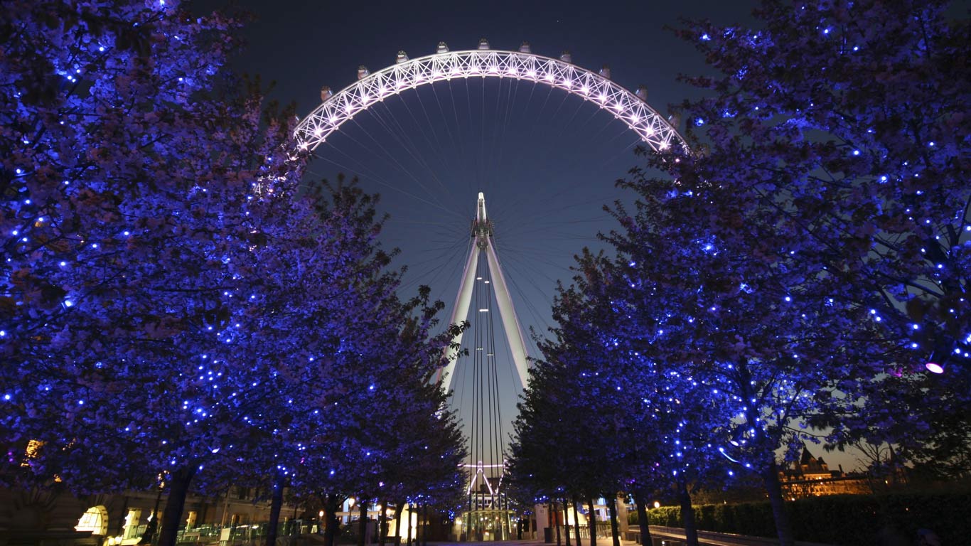 The London Eye at night behind a row of illuminated trees (© rodrigoono/RooM the Agency/Corbis)(Bing United Kingdom)