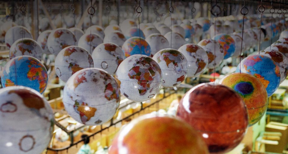 Globes suspended from conveyor track at factory -- Andy Sacks/Getty Images &copy; (Bing United Kingdom)