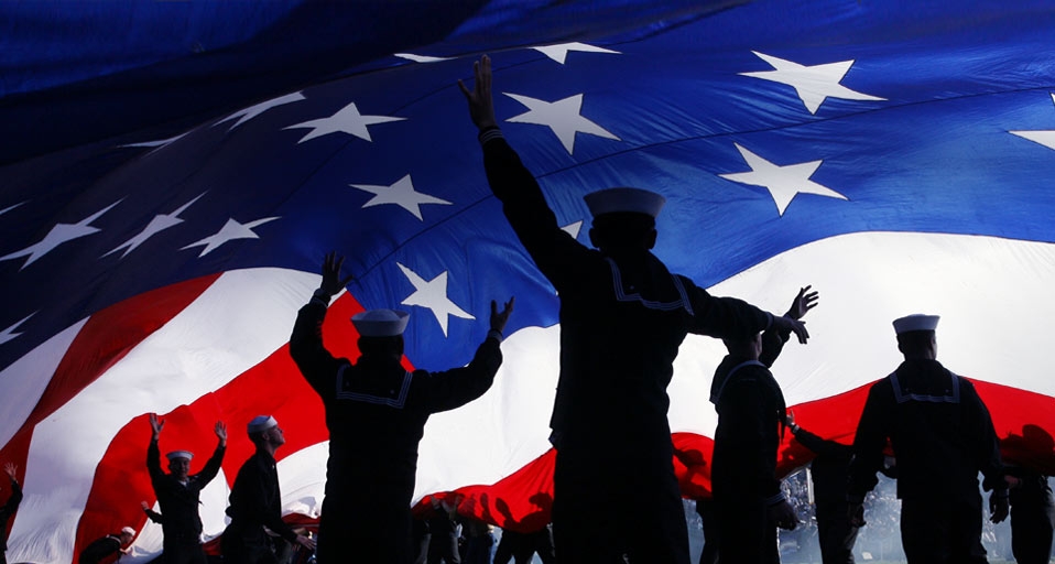 Military personnel stand under a huge American flag preceding a San Diego Chargers football game, San Diego, Calif. -- Robert Benson/Aurora Photos &copy; (Bing United States)