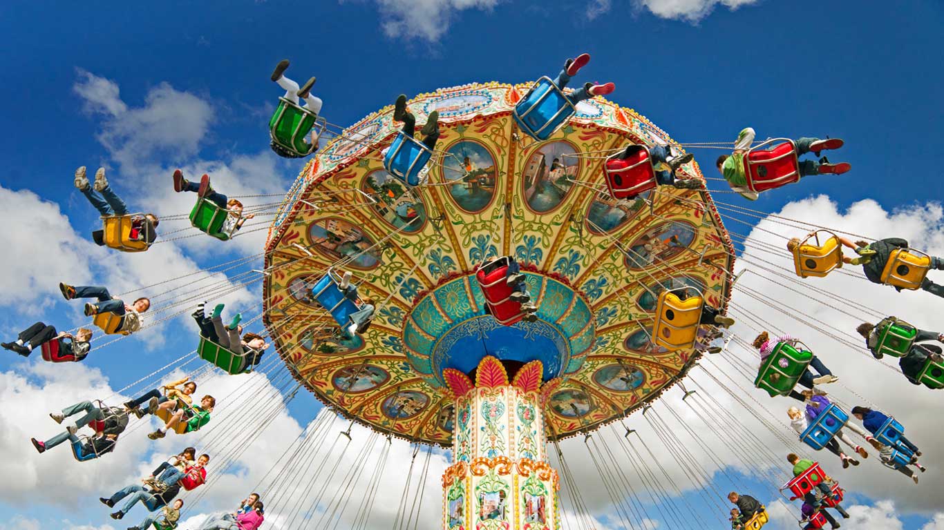 People on a swing ride at a carnival (© Peter Burian/Aurora Photos)(Bing United States)