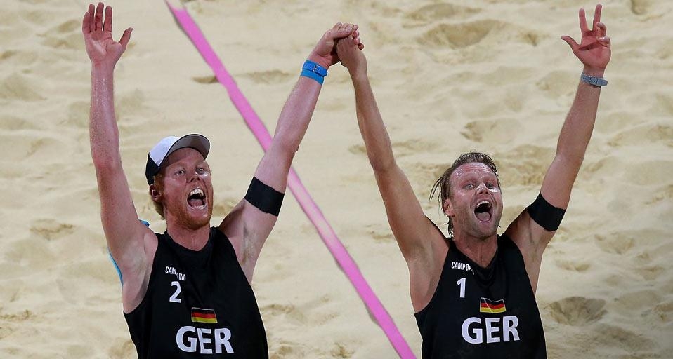 LONDON, ENGLAND – 09. AUGUST: (L-R) Jonas Reckermann und Julius Brink, Deutschland, feiern den gewonnenen Matchball gegen Alison Cerutti und Emanuel Rego aus Brasilien bei dem Goldmedaillenmatch im Männer-Beachvolleyball am 13. Tag der Olympischen Spiele 