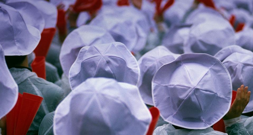Students with white hats and red noisemakers at a baseball game in Osaka, Japan (© Arthur Meyerson/Aurora Photos) &copy; (Bing United Kingdom)