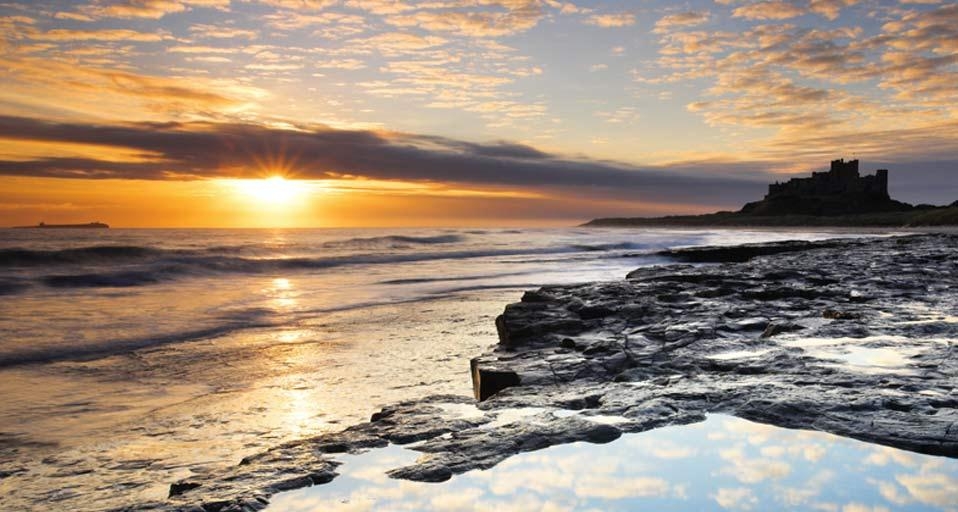 Spectacular sunrise on the coast near Bamburgh Castle, Northumberland, England (© Adam Burton/Age Fotostock) &copy; (Bing United Kingdom)