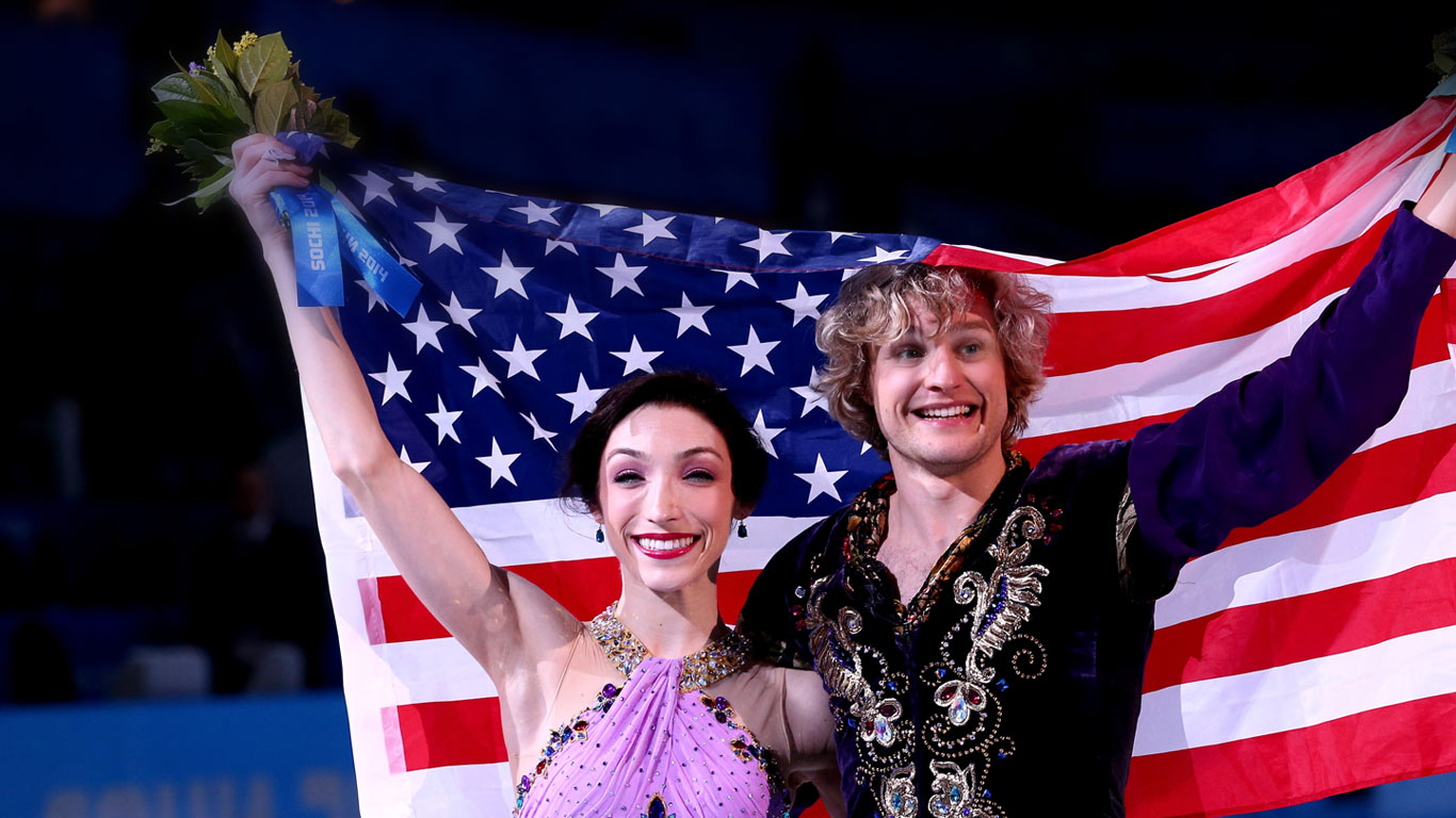 Gold medalists Meryl Davis and Charlie White of the United States celebrate during the flower ceremony for Figure Skating Ice Dance at the 2014 Winter Olympics, February 17, 2014, Sochi, Russia (© Ryan Pierse/Getty Images)(Bing United States)