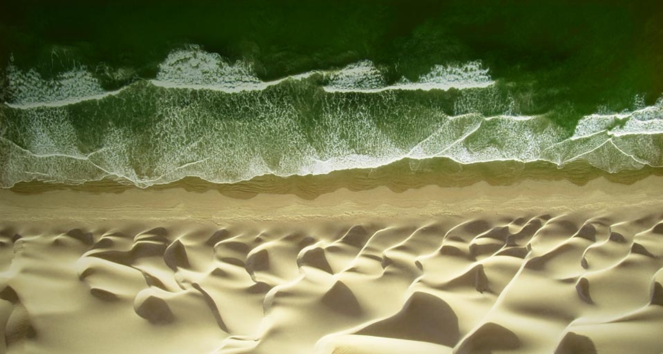 Waves of water meet waves of sand on the beach of the Pacific ocean near Paracas, Peru -- George Steinmetz/Corbis &copy; (Bing United Kingdom)