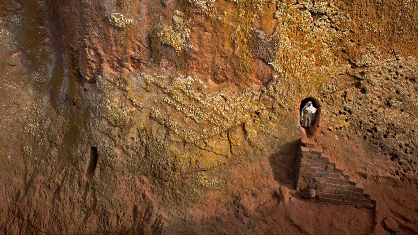 Woman emerges from a tunnel leading to Bet Amanuel, in Lalibela, Ethiopia (© Andrew McConnell/plainpicture)(Bing United Kingdom)