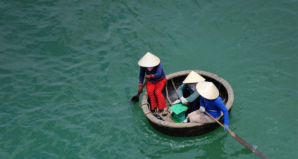 Three women rowing in bamboo basket boat, Vietnam -- Sami Sarkis/Getty Images &copy; (Bing United Kingdom)