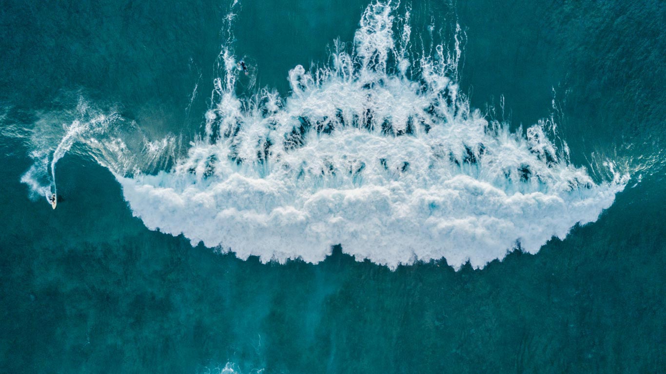 Aerial view of surfer catching a wave, Tenerife, Canary Islands, Spain (© Sergio Villalba/Aurora Photos)(Bing Canada)