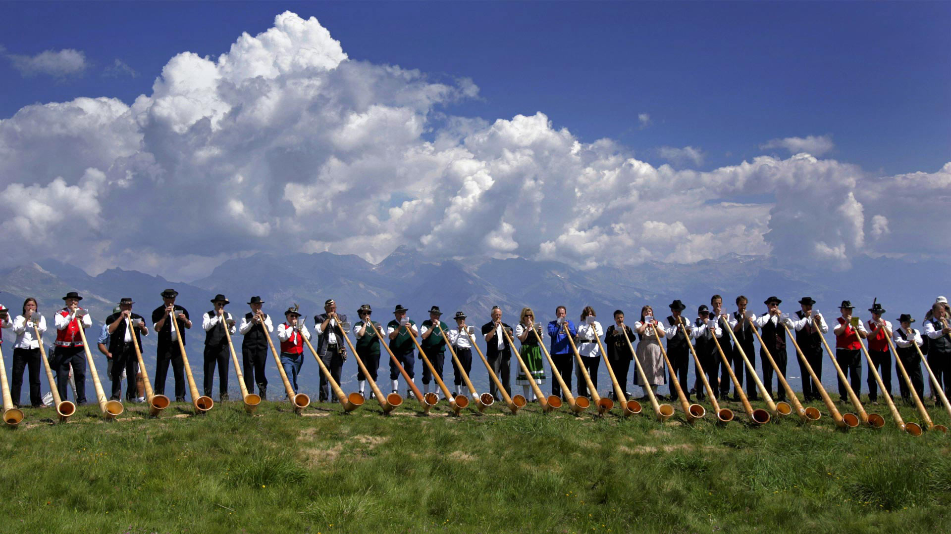 Alphorn musicians perform during the International Alphorn Festival in Nendaz, Switzerland (© Fabrice Coffrini/Getty Images)(Bing United Kingdom)