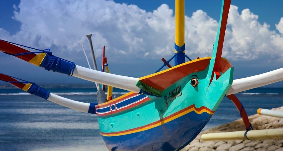 Traditional fishing craft drawn up on the sandy beach of Denpasar, Indonesia  (© Tim Mannakee/Corbis) &copy; (Bing United Kingdom)