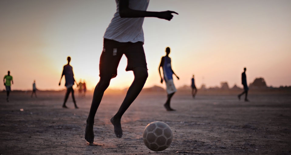 Boys play football on a dusty patch of land, Africa - Roberto Schmidt/Getty Images &copy; (Bing United Kingdom)
